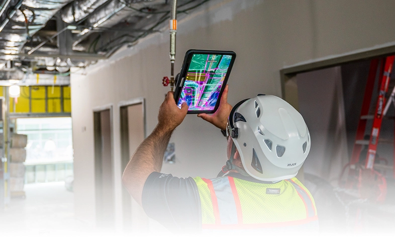 Construction worker using GAMMA AR on tablet.