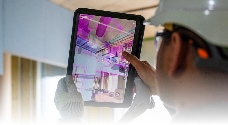 Construction worker using GAMMA AR on tablet.