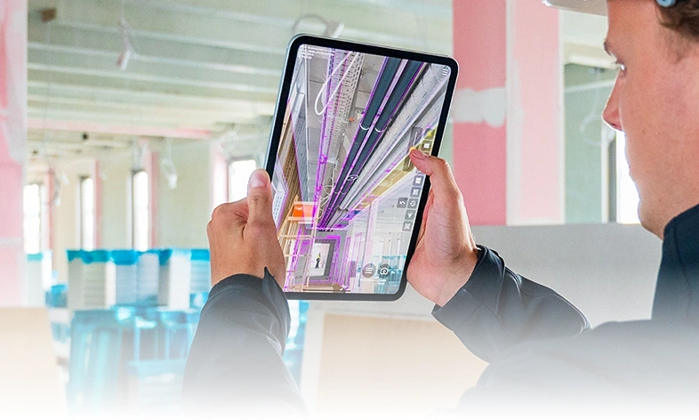 Construction worker using GAMMA AR on tablet.