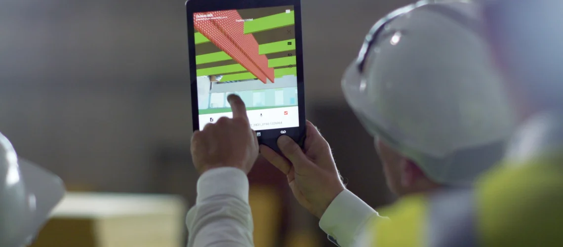 bim-augmented-reality-app-on-construction-site-gamma-ar construction worker showing augmented reality for construction